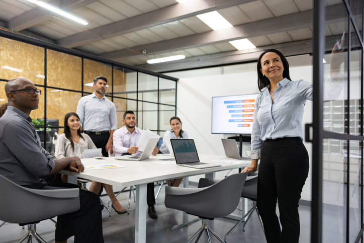 Woman making a presentation to her team in a business meeting
